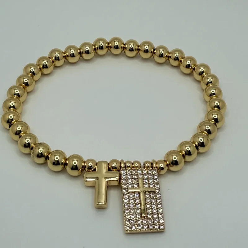 Pulsera elástica de bolas con cruz y cristales