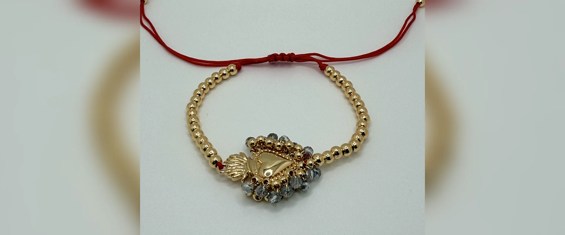 Bead bracelet with crystal heart and red cord