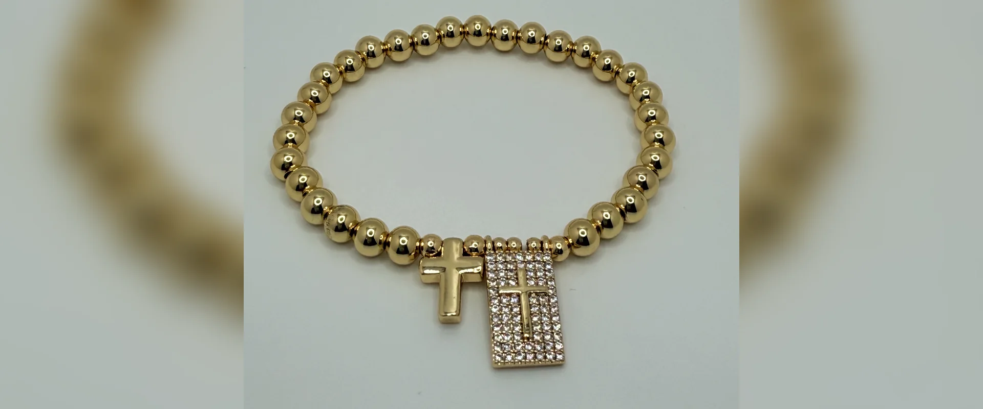 Stretch bead bracelet with cross and crystals
